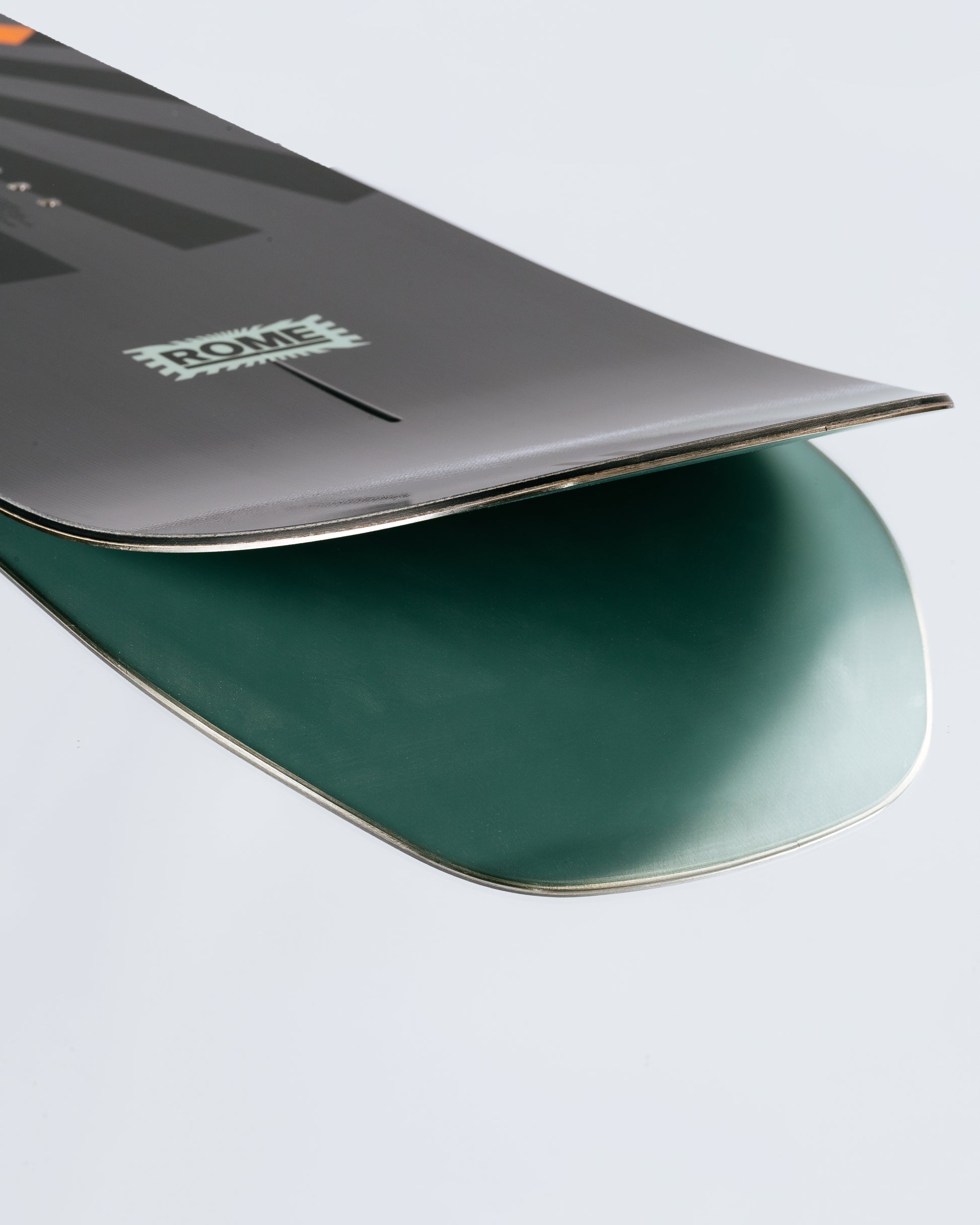 The tail and base of the freeride snowboard with HotRods and Impact base. Mechanic 2025 | Rome Snowboards™